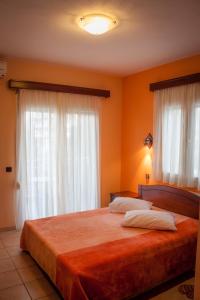 Postel nebo postele na pokoji v ubytování Filippion Hotel