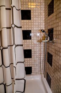 a bathroom with a shower with a white tub at Soba Lana in Jajce