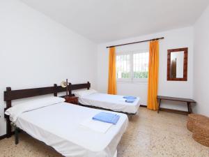 two beds in a room with a window at Holiday Home Carlos by Interhome in Cambrils