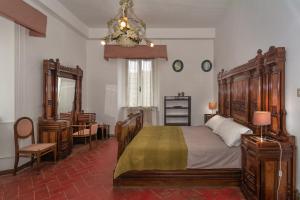 a bedroom with a bed and a desk and a mirror at Villa Eugenia in Livorno