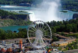 a ferris wheel in front of a waterfall at Gracies Fallsview Getaway in Niagara Falls