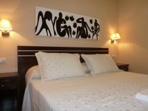 a bedroom with a bed with two white pillows at Hostal Mayor in Madrid