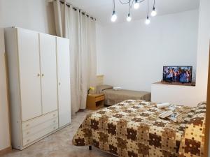 a bedroom with a bed and a large white cabinet at B&B Casa Alessandro in Scalea