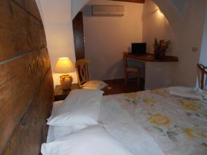 a bedroom with a bed and a table with a lamp at Casa Alianda in Telti +18 photos