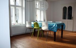 a dining room with a blue table and chairs at Akác Ház in Feked