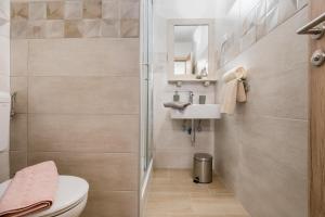 a bathroom with a toilet and a sink at Apartment Cesarica in Baška Voda +17 photos
