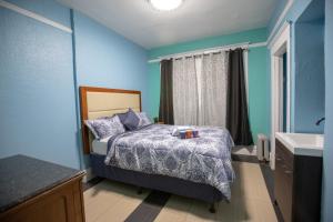 a blue bedroom with a bed and a sink at Sunnyside Hotel-Downtown San Francisco in San Francisco +24 photos