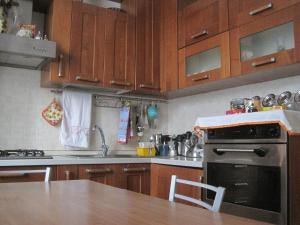 a kitchen with wooden cabinets and a sink and an oven at Il Giardino di Venere in Terni