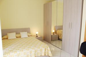 a bedroom with a bed with two pillows at Casa, Mare-Etna-Taormina in Fondachello +44 photos
