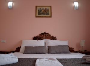 a bed with a white comforter and pillows on it at Hotel "VIR" in Velika Plana