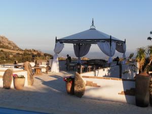 a gazebo with a table and chairs and flowers at Casa Alianda in Telti