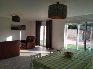 a living room with a table with a green and white checkered table cloth at Casa da Tia Dulce in Pataias