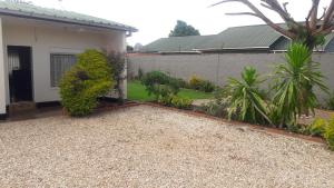 a garden in front of a house at Furnished self catering cottage in Lusaka