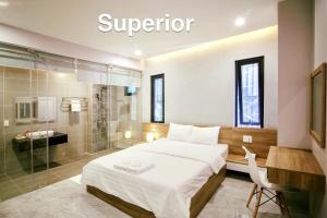 a hotel room with a bed and a shower at La Galerie Hotel in Ho Chi Minh City +51 photos