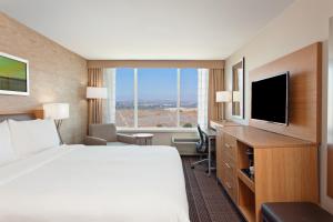a hotel room with a bed and a flat screen tv at Holiday Inn Diamond Bar - Pomona, an IHG Hotel in Diamond Bar
