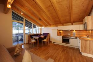 a kitchen and dining room with a table and chairs at Gästehaus Weber in Oberperfuss