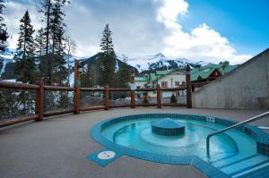 a swimming pool on a patio with mountains in the background at Lizard Creek Lodge in Fernie