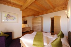 a bedroom with a bed and a wooden ceiling at Gästehaus Weber in Oberperfuss