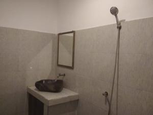a bathroom with a sink and a mirror at ALMAIDA II Gili Trawangan in Gili Trawangan