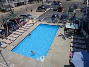 an overhead view of a swimming pool with people in it at Quarterdeck Motel in Wildwood
