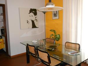 a dining room with a glass table and chairs at B&B Come A Casa in Cerrione