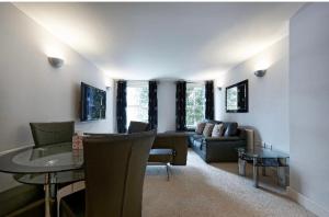 a living room with a couch and a table at Copperfield Apartment in Canterbury