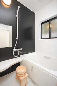 a bathroom with a toilet and a black wall at Fuji Time traveler 新館 in Fujikawaguchiko
