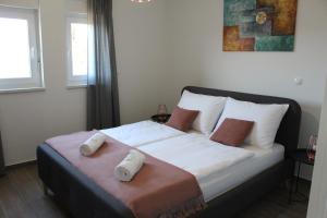 Postel nebo postele na pokoji v ubytování Maristo Apartments