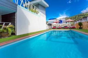 a large blue swimming pool next to a building at PJ Patong Resortel in Patong Beach