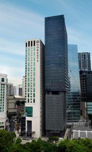 a tall building in a city with tall buildings at Dorsett Kuala Lumpur in Kuala Lumpur