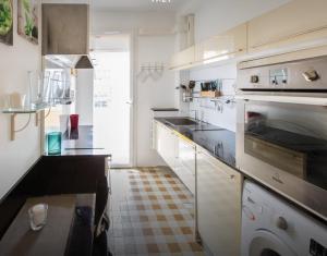 a kitchen with white cabinets and stainless steel appliances at Stunning 2 bed Flat Nice front of the beach Seaview in Nice