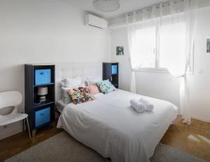 a bedroom with a white bed with towels on it at Stunning 2 bed Flat Nice front of the beach Seaview in Nice