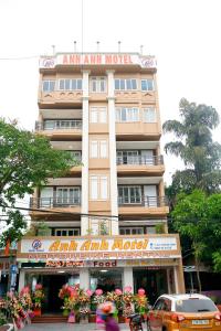 a tall building with a sign on top of it at Anh Anh Guest House in Ha Giang