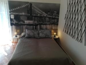 a bedroom with a bed with a bridge picture on the wall at Guesthouse Porec in Poreč