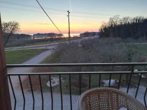 a room with a balcony with a view of a road at Guesthouse Porec in Poreč