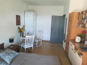 a bedroom with a bed and a table and chairs at Guesthouse Porec in Poreč