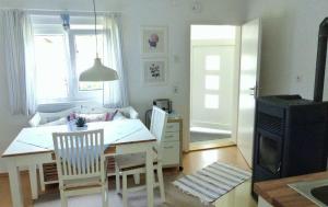 a kitchen and dining room with a table and chairs at Ferienhaus Tante Liesl's Häusl in Marktleuthen