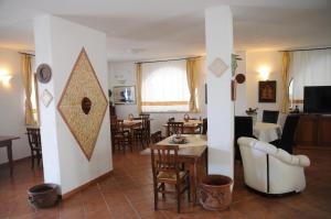 a living room with tables and chairs and a living room at Villa Grazia in Capo Vaticano