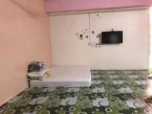 a small room with a bed and a flat screen tv at langkawi homestay murah in Kuah