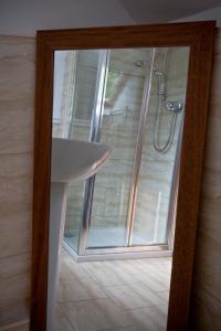 a bathroom with a shower and a white sink at Lugonia in Pitlochry