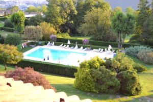 a swimming pool in the middle of a garden at Residenza San Martino in Cissano