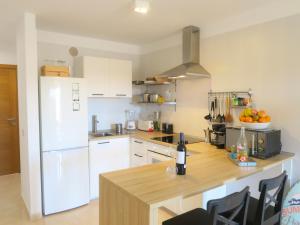 a kitchen with white appliances and a wooden counter top at MEDANO4YOU Pearl Flavour Holiday Home in El Médano