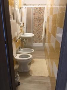 a bathroom with a toilet and a sink at Locanda Ponte Rosa in Garessio +22 photos