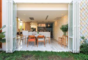 a dining room and kitchen with a table and chairs at Pastell Oldtown Chiang Mai in Chiang Mai +117 photos