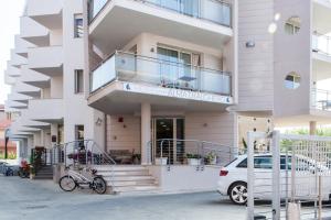 a building with a bike parked in front of it at Alma di Alghero Hotel in Alghero