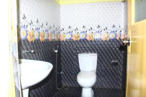 a bathroom with a white toilet and a sink at Ayos Hill Adam's Peak Free Shuttle in Adams Peak +69 photos