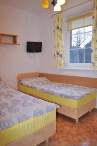 a room with two beds and a window at Helena in Karwia