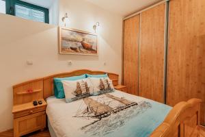 a bedroom with a bed with a wooden headboard at Stone House Herceg Novi in Herceg-Novi