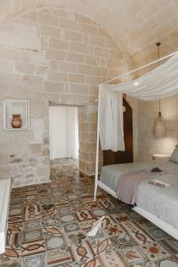 
a bedroom with a bed and a wall at Cenobio Hotel in Matera
