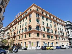 a large building with cars parked in front of it at Oasi Santa Lucia in Naples